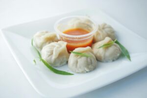 Read more about the article The Journey of Momo: From Tibetan Plains to Global Plates